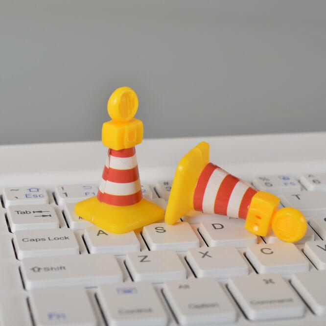 Traffic cones and laptop keyboard. Driving website traffic to SCBA.