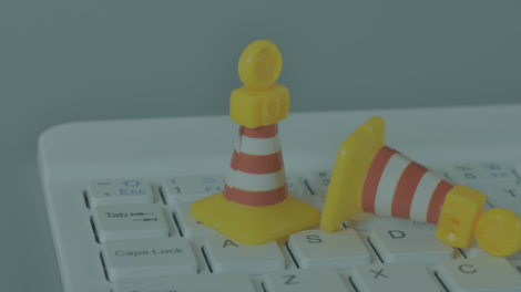 Traffic cones and laptop keyboard. Driving website traffic to SCBA.