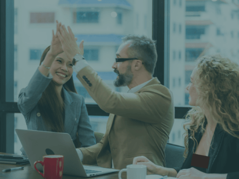 Image of three people in the office celebrating by doing a high five to show that HomeCare LaunchPad Startup solution helps you be successful.